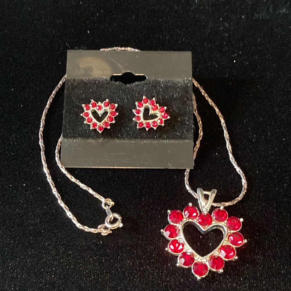 Heart shaped silvertone red rhinestone earring and necklace set.